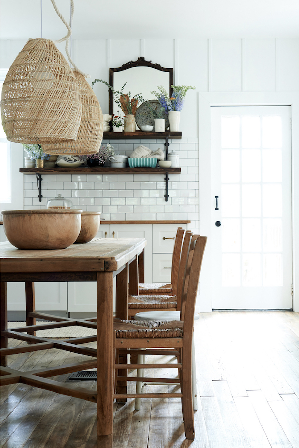 Leanne Ford designed kitchen with subway tile, rustic wood table and open shelving.