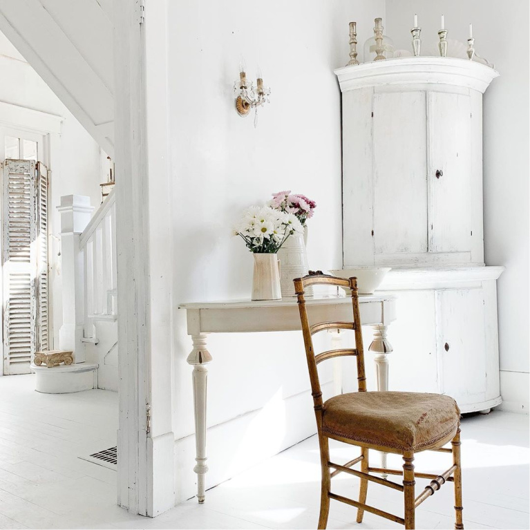 White Swedish cottage kitchen with antiques and white painted hardwood floors - My Petite Maison.