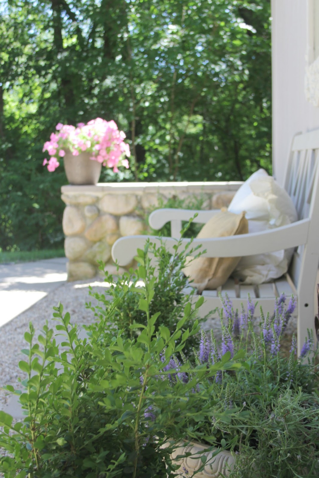 French inspired courtyard with lavender, pea gravel, bench, and stone wall. Come see more of my home in Hello Lovely House Tour in July. #hellolovelystudio #timeless #tranquil #interiordesign #europeancountry #europeanfarmhouse #simpledecor #serenedecor