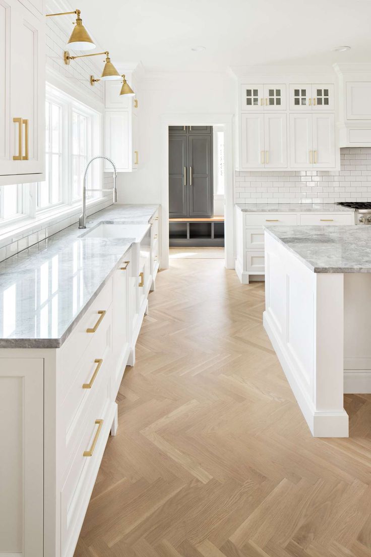 Classic coastal style white kitchen reminiscent of Something's Gotta Give kitchen! Herringbone pattern for wood floor in white kitchen. White English farmhouse style home by The Fox Group. Come be inspired these English Farmhouse Style Decorating Ideas. #modernfarmhouse #englishfarmhouse #interiordesignideas #farmhousestyle #decoratingideas #kitchendesign #whiteoak #herringbone #woodfoor