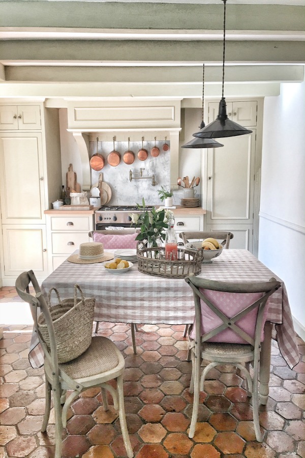 French farmhouse kitchen with putty color cabinets and antique tile terracotta hex floor - Vivi et Margot.