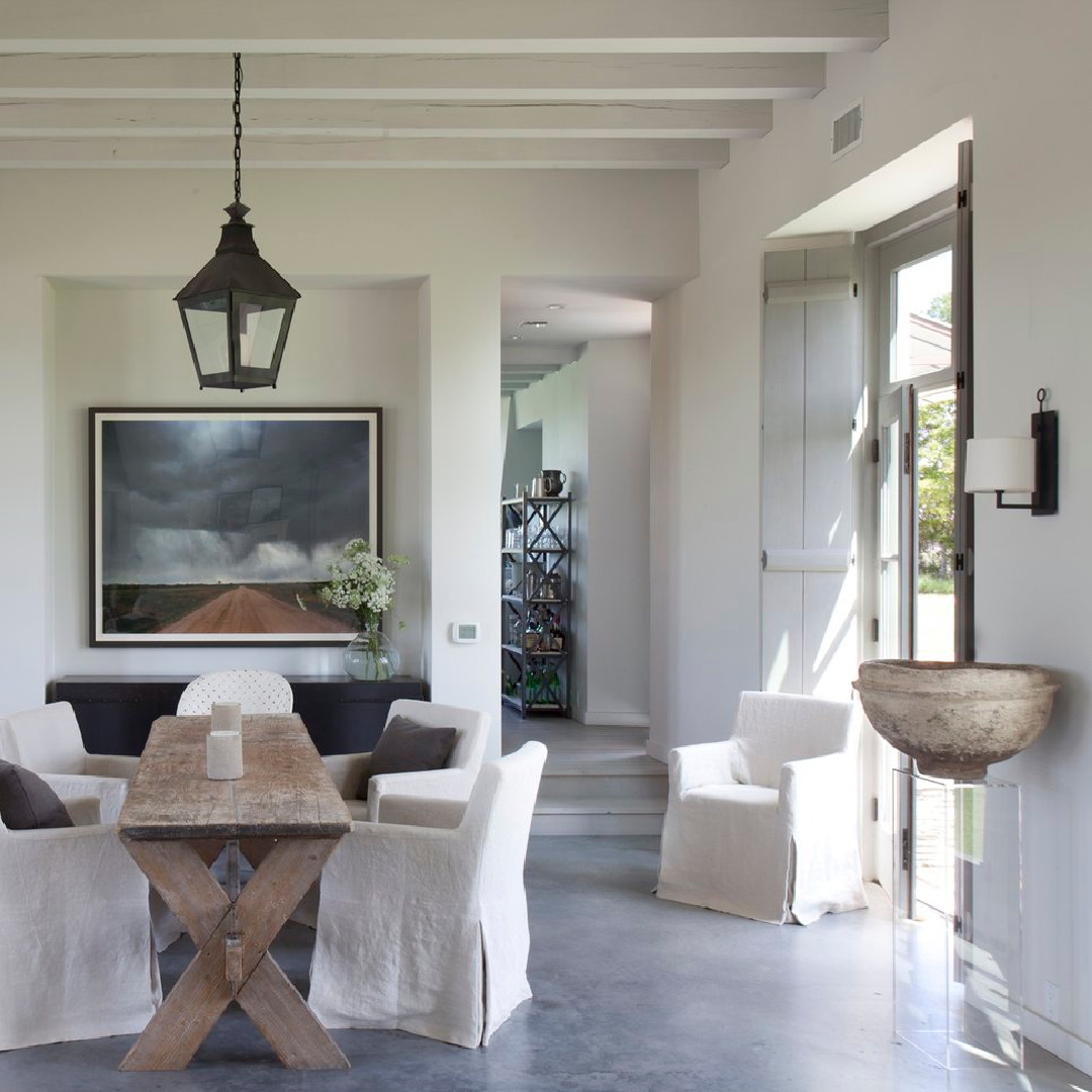 Dining area with antique orchard table in Eleanor Cummings designed modern French farmhouse near Round Top, TX in MILIEU magazine. #modernfrench #europeancountry
