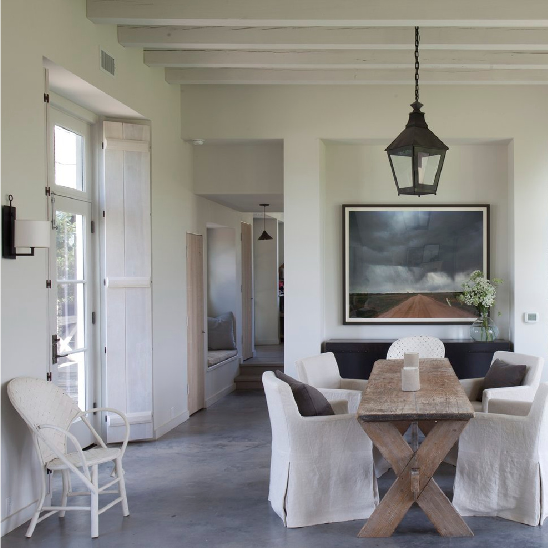 Dining area with antique orchard table in Eleanor Cummings designed modern French farmhouse near Round Top, TX in MILIEU magazine. #modernfrench #europeancountry
