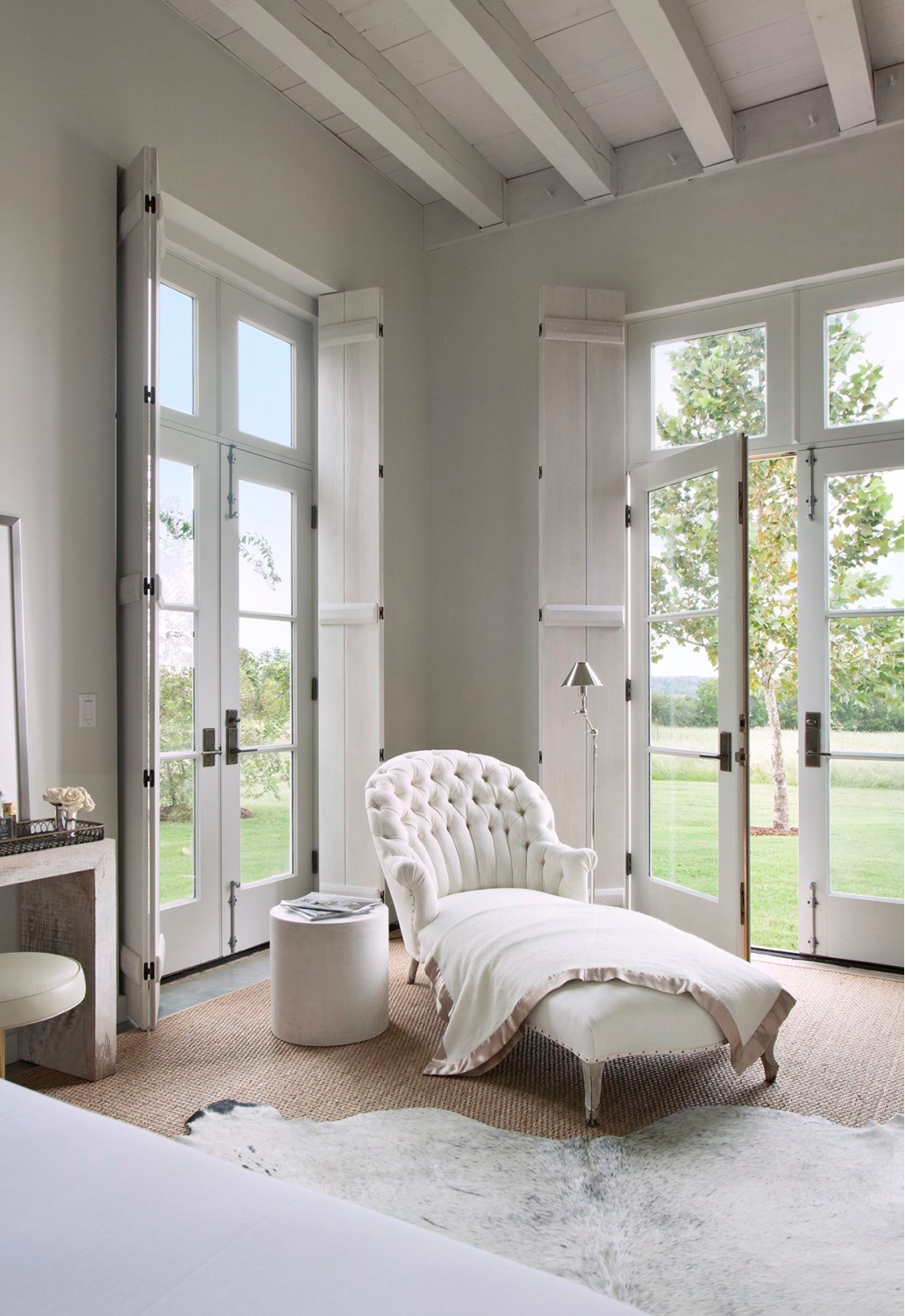 Chaise in bedroom of Eleanor Cummings designed modern French farmhouse near Round Top, TX in MILIEU magazine. #modernfrench #europeancountry