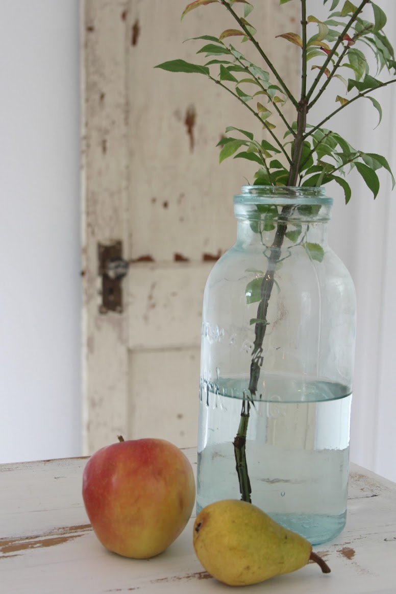 Hello Lovely's rustic modern French table and antique jar.