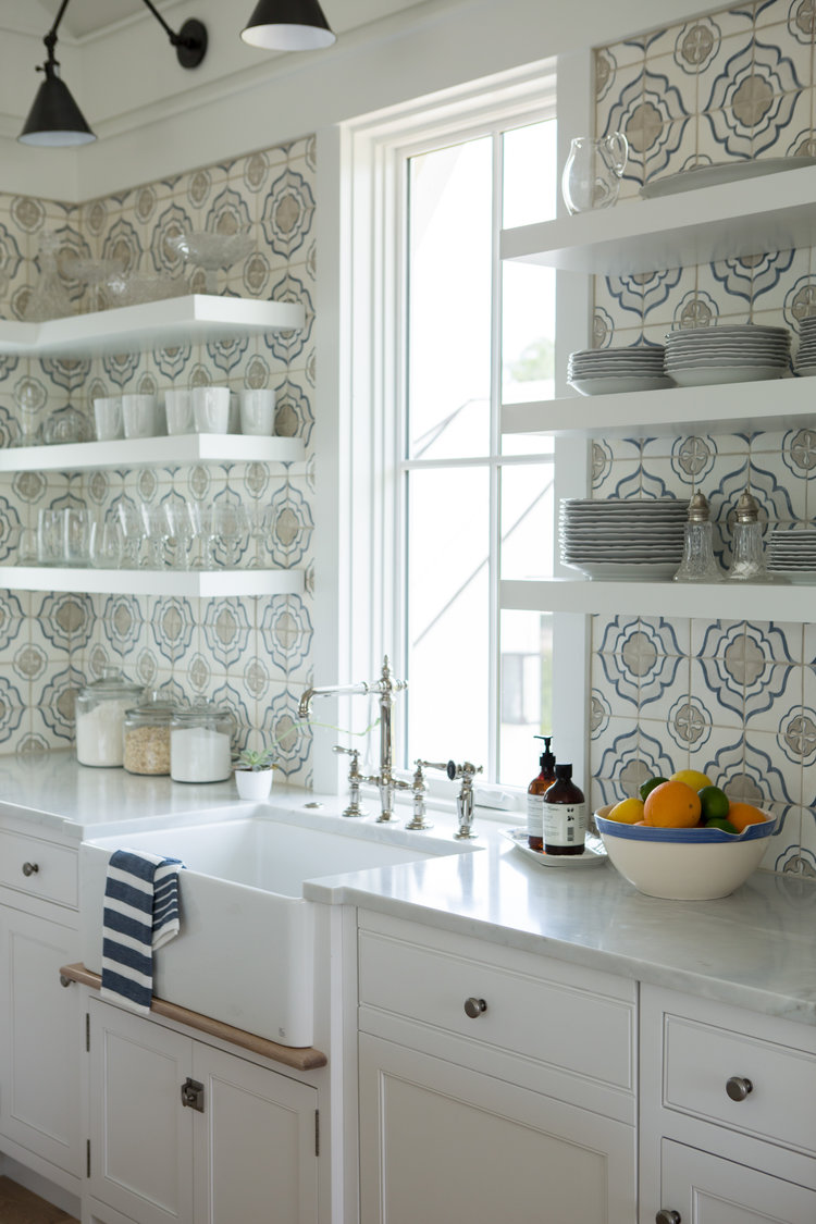 Classic coastal style white kitchen reminiscent of Something's Gotta Give kitchen! Modern farmhouse kitchen with floating shelves, farm sink, and shiplap. Coastal Cottage Interior Design Inspiration - Part 1 {Get the Look!} #kitchendesign #modernfarmhouse #farmhousekitchen #floatingshelves #farmsink