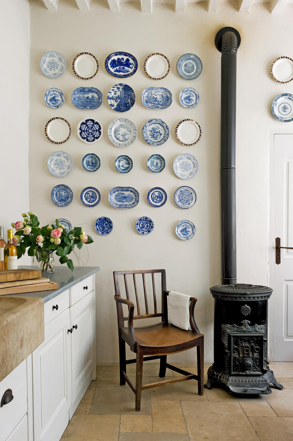 Blue plates displayed on wall in a French farmhouse kitchen in Provence - Your Haven in Paris, Provence...