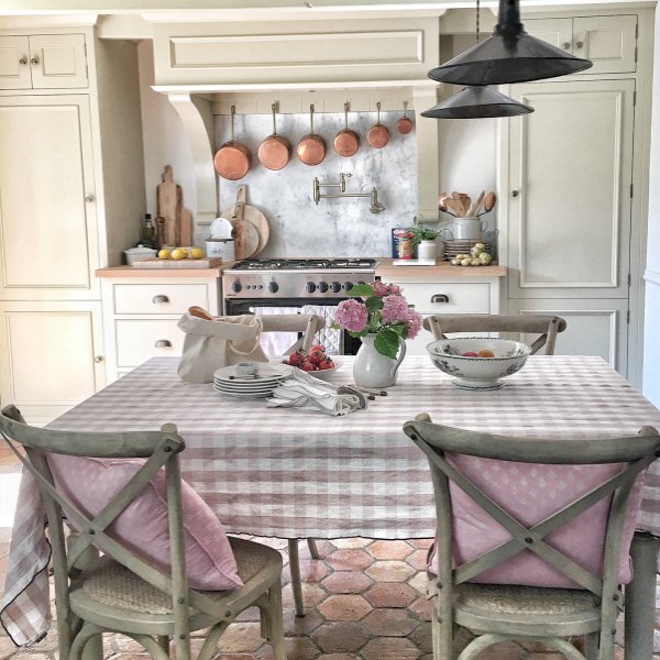 Charming French kitchen by Vivi et Margot with check linens in dusty rose.
